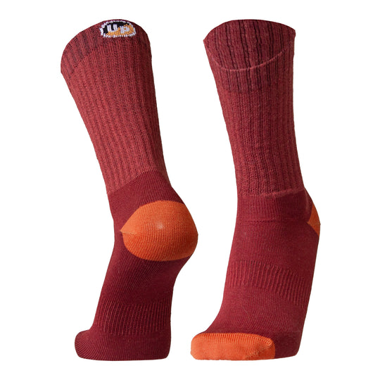 Pair of maroon socks with orange toes and heels on a white background